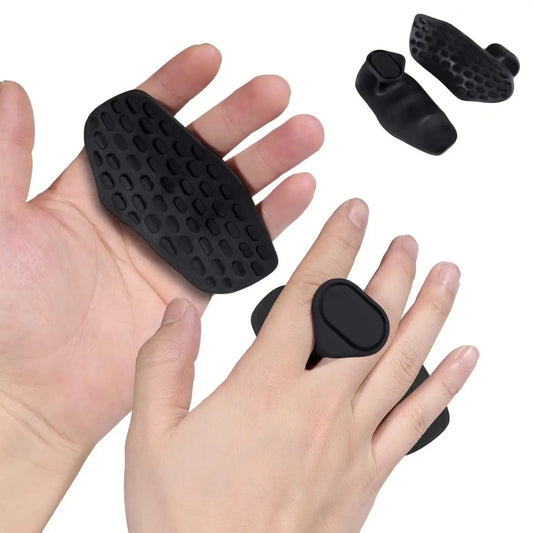 Black finger protectors on a hand with additional protectors on a white background