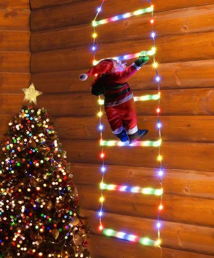 Santa Claus figure climbing a ladder made of Christmas lights against a wooden wall with a decorated tree.