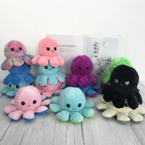 Set of colorful octopus plush toys on a light wooden surface with a white background.