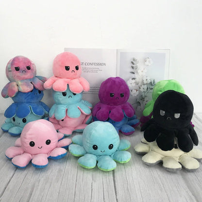 Set of colorful octopus plush toys on a light wooden surface with a white background.